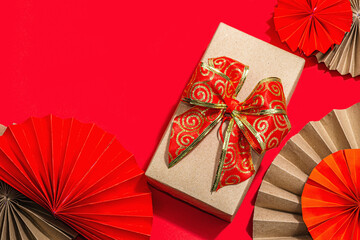 Happy Chinese New Year gift concept. Oriental asian style paper fans, traditional decor on red