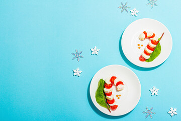 Caprese salad in form of a Christmas candy cane. Traditional New Year design, festive decoration