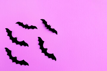 Halloween concept. Black bats on an lilac background with place for text . Top view, flat lay, copy space