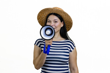 Fototapeta premium Young asian woman in a brim straw hat is announcing something in megaphone. Isolated on white.