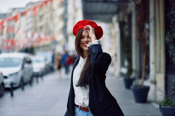 Happiness woman walks walks in the city against the backdrop of office buildings, stylish fashionable vintage clothes and make-up, spring walk, travel.