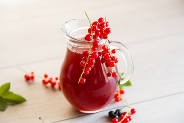 fresh berry juice from red and black currant, on a wooden table