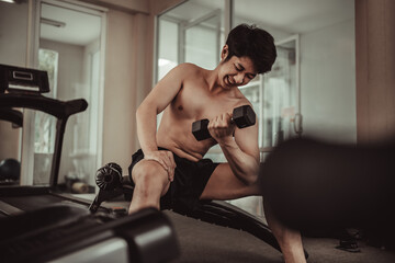 Muscular Young Man Exercising with Dumbbells in Gym - Strength Training and Fitness Concept, Active Gym Workout, Fitness and Determination.