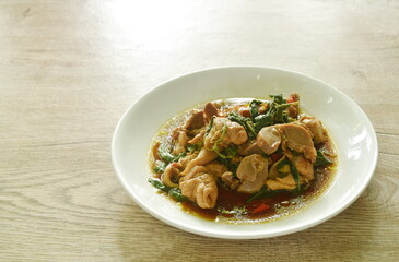 spicy stir-fried chili chicken meat and gizzard with basil on plate
