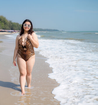 Portrait young woman asian chubby cute beautiful oneperson in bikini brown sexy front viewpoint tropical sea beach white sand clean and bluesky background calm Nature ocean Beautiful wave water travel