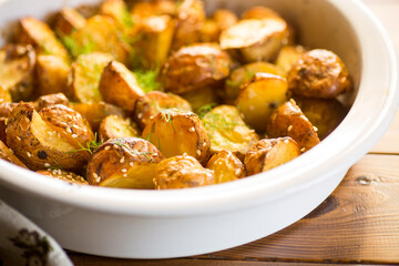 potatoes baked with sesame seeds, herbs and spices in the oven