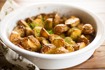 potatoes baked with sesame seeds, herbs and spices in the oven