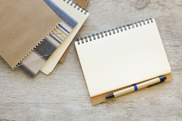 Blank notepad on a wooden table. view from above