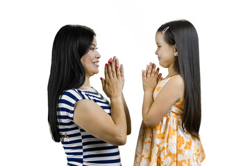 Young asian mother playing patty cake game with her daughter. Isolated on white.