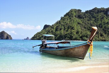 Naklejka na ściany i meble wooden boat on a beach in Asia 