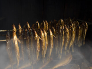 smoking fish in a wooden smokehouse.