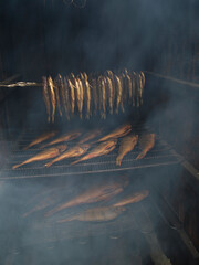 smoking fish in a wooden smokehouse.