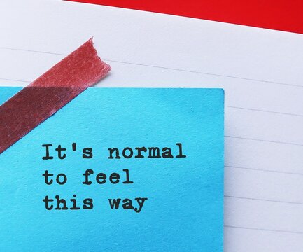 Notebook with handwritten text note - It’s normal to feel this way - self validation affirmation to accept one own feelings and needs without judgment