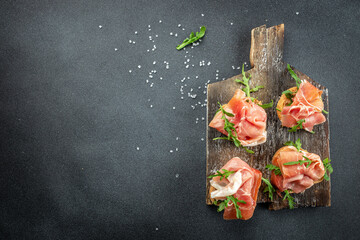 Open sandwich set with cream cheese, prosciutto on a wooden board. banner, menu, recipe place for...