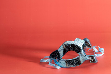 Venetian carnival mask, forming frame in one of the lower corners with space for text