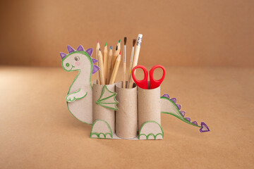 dragon shape a pencil holder made out of toilet paper and a pair of scissors, educational and craft...