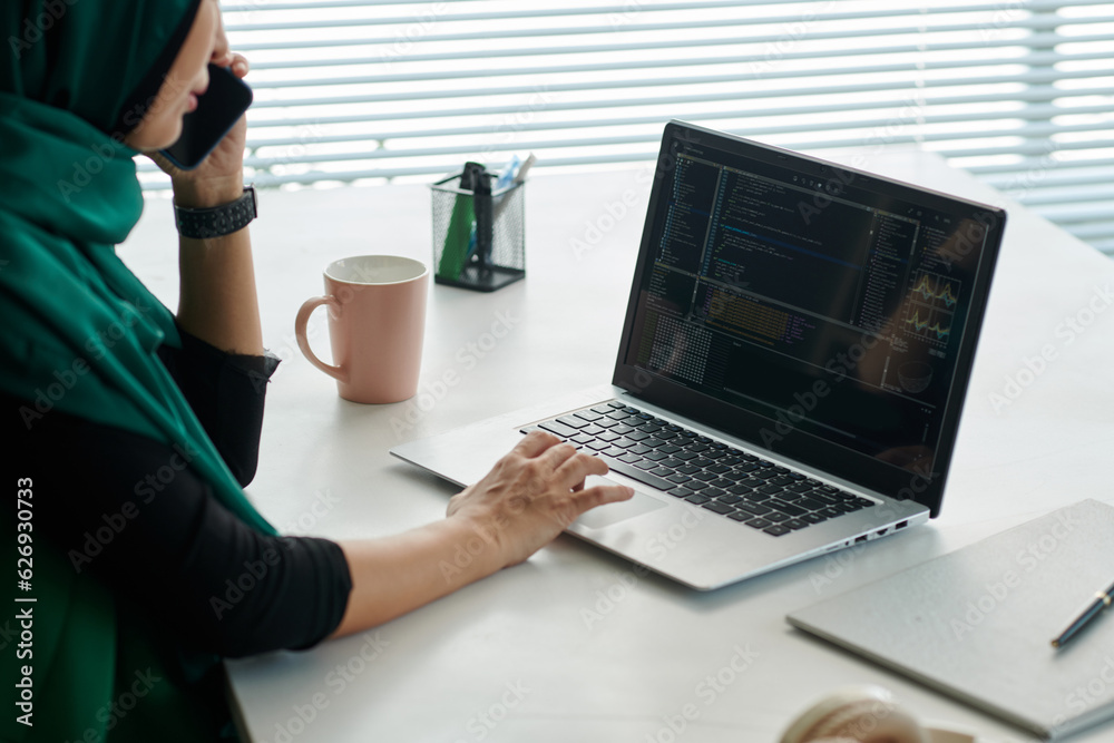 Wall mural cropped image of muslim woman calling coworker to discuss problems with programming code
