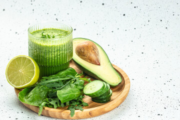 Food and drink, healthy dieting and nutrition. Green smoothie on a blue background, clean eating for weight loss. place for text