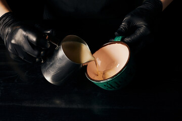 cropped, barista in latex gloves preparing cappuccino, espresso, latte art, pitcher with milk