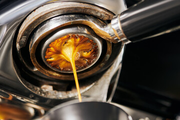 black coffee, extraction, fresh espresso dripping into cup, professional coffee machine
