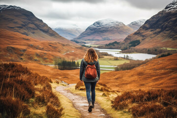 Woman traveling in Scottish highlands. Happy young traveler exploring in nature. - obrazy, fototapety, plakaty