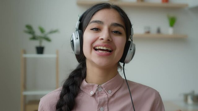 Webcam view Arabian woman smiling girl blogger businesswoman internet tutor business coach in headphones talk to camera greet video meeting call online webinar lesson young student distant education