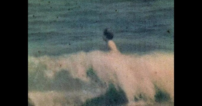 Little boy having fun, swimming in blue sea. Active child playing in sea waves in sunny summer beach. Holiday on ocean. Happy childhood. Archival vintage color film. Archive video. Old retro 1990s