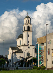 Fototapeta na wymiar Orthodox church against big bright cloud