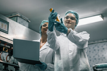 Water Quality Officer tests factory water with pH meter for safety, preventing contamination.