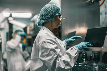 Water Quality Officer tests factory water with pH meter for safety, preventing contamination.