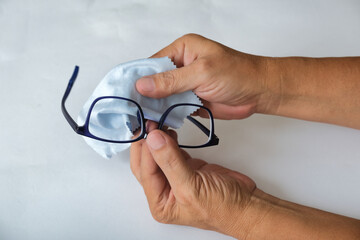 Asian male hands cleaning glasses