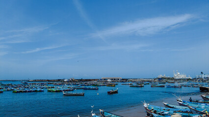 Vizhinjam fishing harbor, Thiruvananthapuram, Kerala, bright blue sky, seascape view