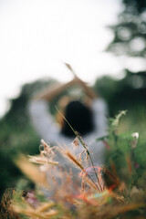 Happy girl artist in the field writes pictures, dreams, poses