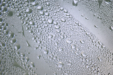 water drops delicately clinging to a glass surface
