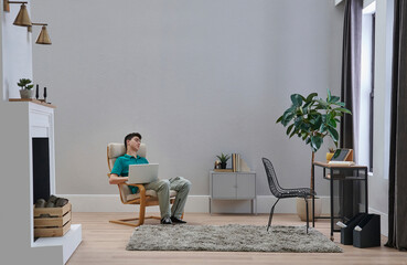 Teenage male person working and study lesson in the room, decorative interior style, chair table and plant design.