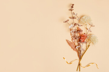 Dry flowers bouquet on beige background with copy space.Autumn vibes