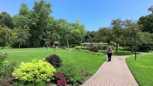 A woman walking in Rosetta McCains Gardens and public park in Toronto, Canada