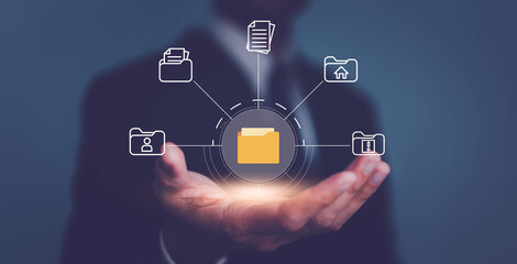 Businessman kolding folder and document icon and manage files online document database, Document management system concept.