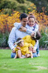Fototapeta premium Family of four having fun outdoors in a beautiful sunny day at the park. Happiness concept. Family concept.