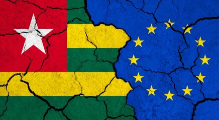 Flags of Togo and European Union on cracked surface - politics, relationship concept