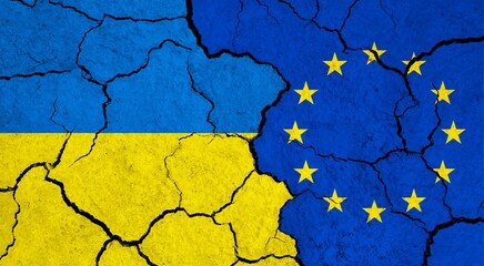 Flags of Ukraine and European Union on cracked surface - politics, relationship concept