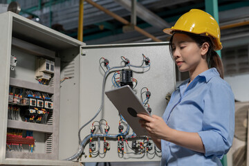 Mechanic or maintenance or electrical engineer checking main electrical control systems industrial plant. Utility fore man daily check power systems in process. Main Distribution Board, Switchboards