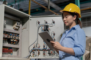 Mechanic or maintenance or electrical engineer checking main electrical control systems industrial...