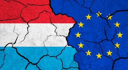 Flags of Luxembourg and European Union on cracked surface - politics, relationship concept