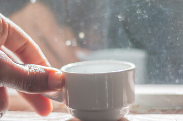 Coffee cup with reflection in the glass,the glass is dirty purposely,simple living concept