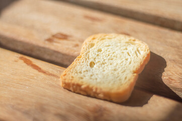 bread in the form of toast on a wooden surface with natural light