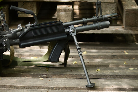 airsoft weapon m60, black weapon on the floor stands on bipods