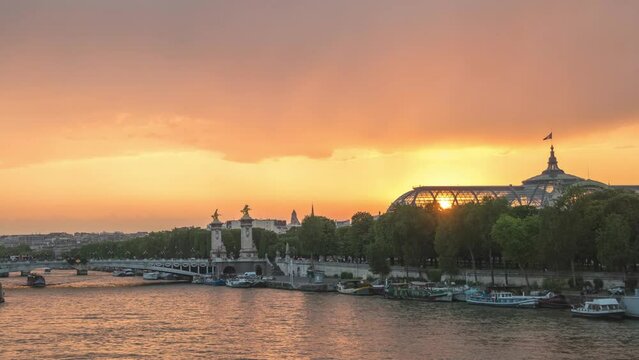 Paris France time lapse 4K, city skyline day to night sunset timelapse at Seine River with Pont Alexandre III bridge and Grand Palais