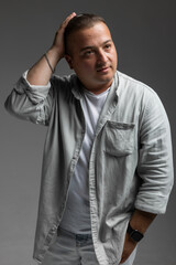 a man with a white full hand shirt open button with white shirt posing in a different emotions in a white background
