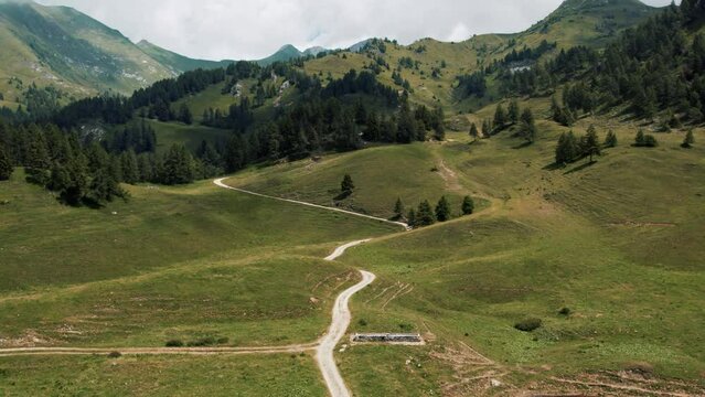 Aerial view from a drone of the Crocedomini Pass in Lombardy. Majestic landscape of the Alps on a sunny day with passing clouds.